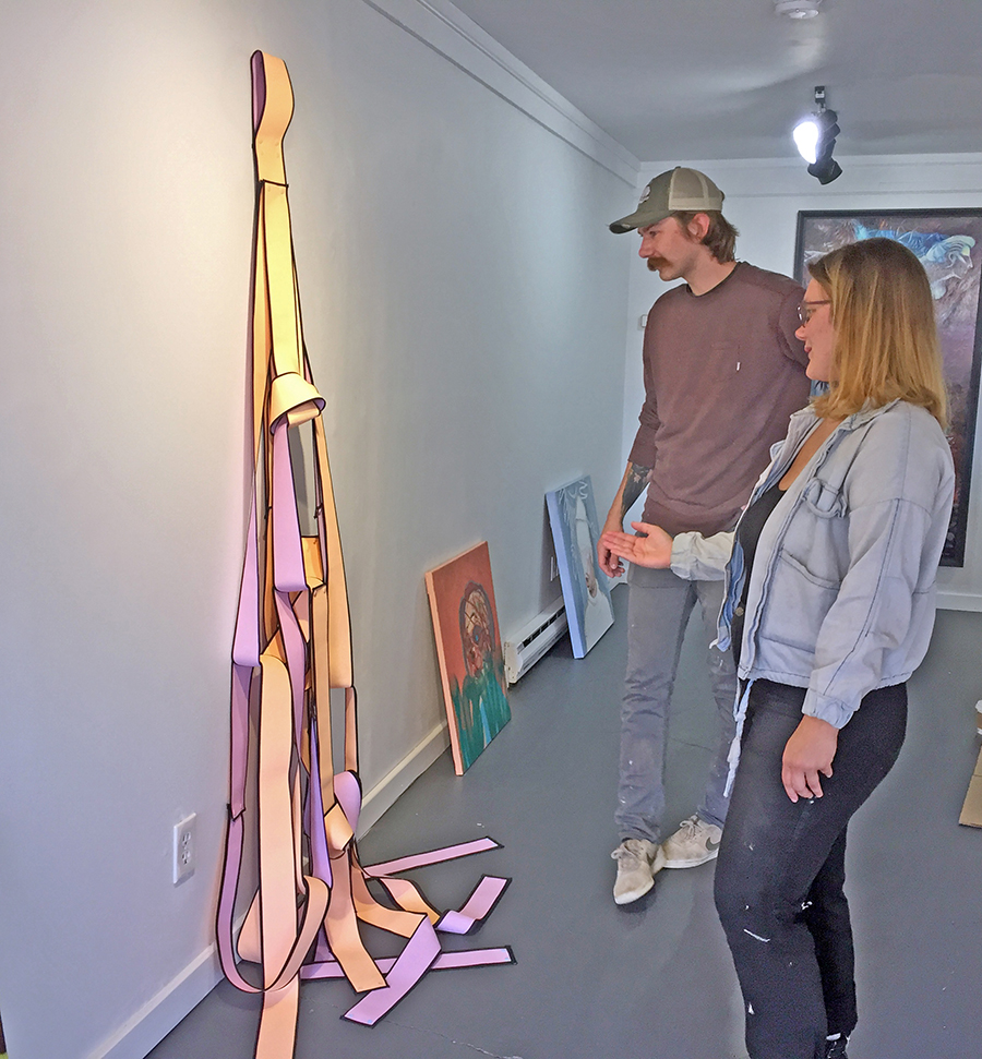 Gallery 610 is planned as a bridge between UW-Stout and the Menomonie community through art. Emily Gordon, foreground, and Jared LeClaire discuss a sculpture that is part of a new juried show.
