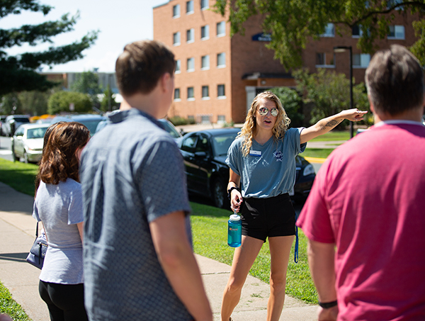 UW-Stout student Carly Segulia talks with visitors recently while leading a campus tour for the Admissions Office.