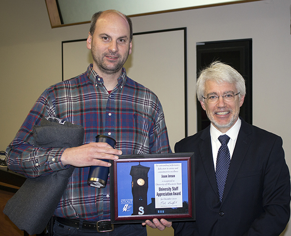 Jason Jenson, left, received the University Staff Employee Appreciation Award for December at UW-Stout from interim Chancellor Patrick Guilfoile.
