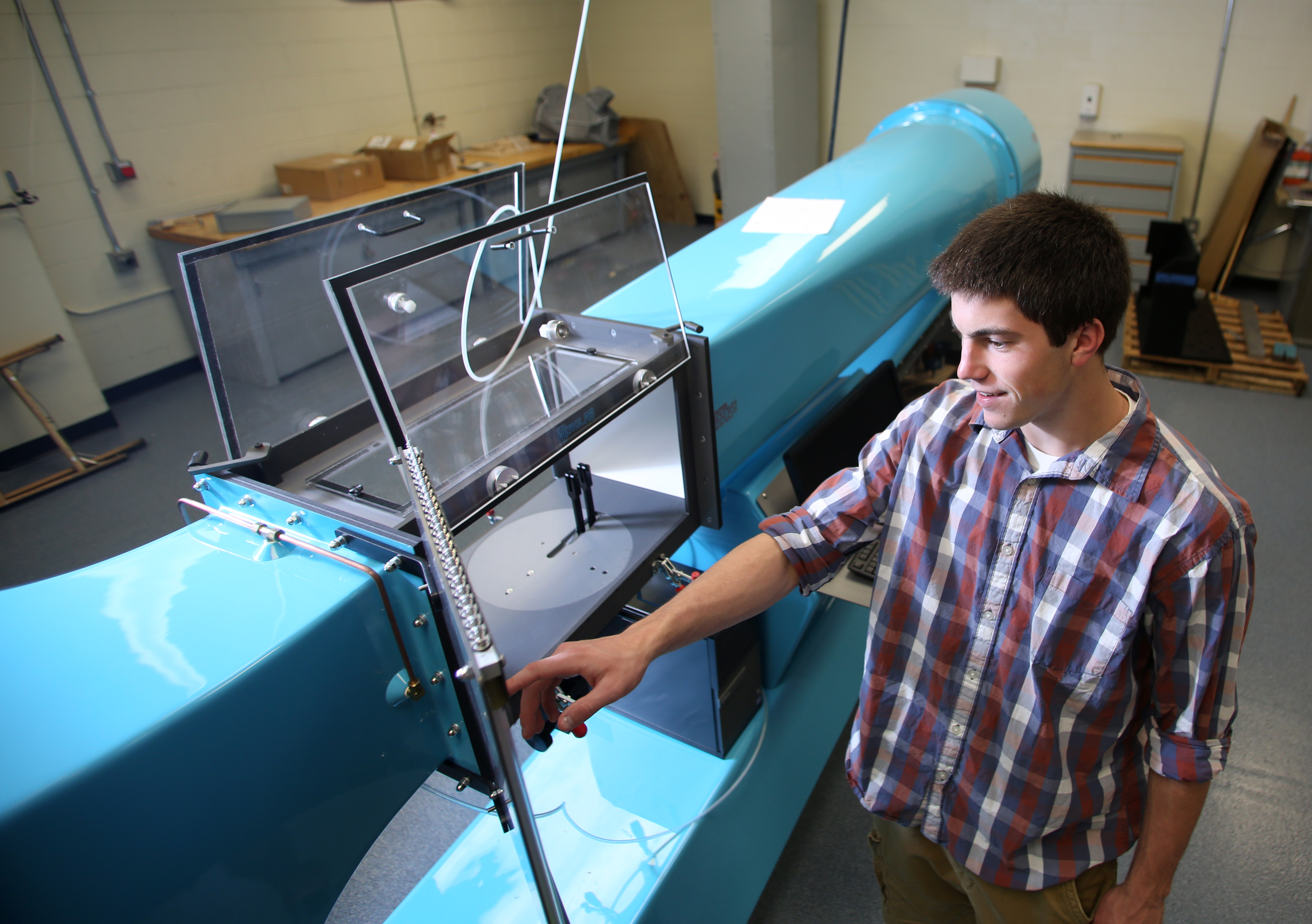 Student engages with wind tunnel equipment