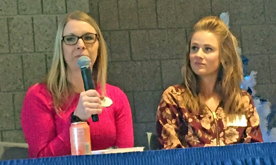 UW-Stout alumna Rachel Funk-Johnson speaks at a panel on mental health, while Hamann listens.