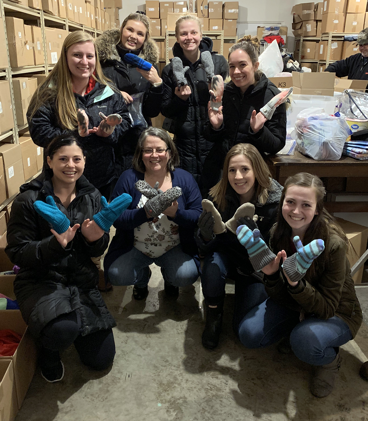 Members of Phi Upsilon Omicron-Tau Chapter drop mittens off at the Wisconsin Foster Closet.