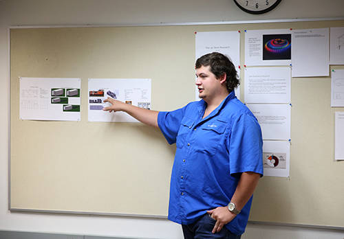 UW-Stout student Zach Johnson, mechanical engineering, explains a pop-up arcade store design concept that Marilyn Fanetti of Menomonie wants to see built. 