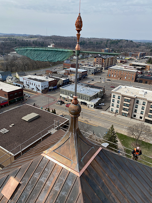 The 122-year-old Bowman Hall quill and the torch above it have been restored. The copper on the cupula, which sits on the new roof, had to be replaced.