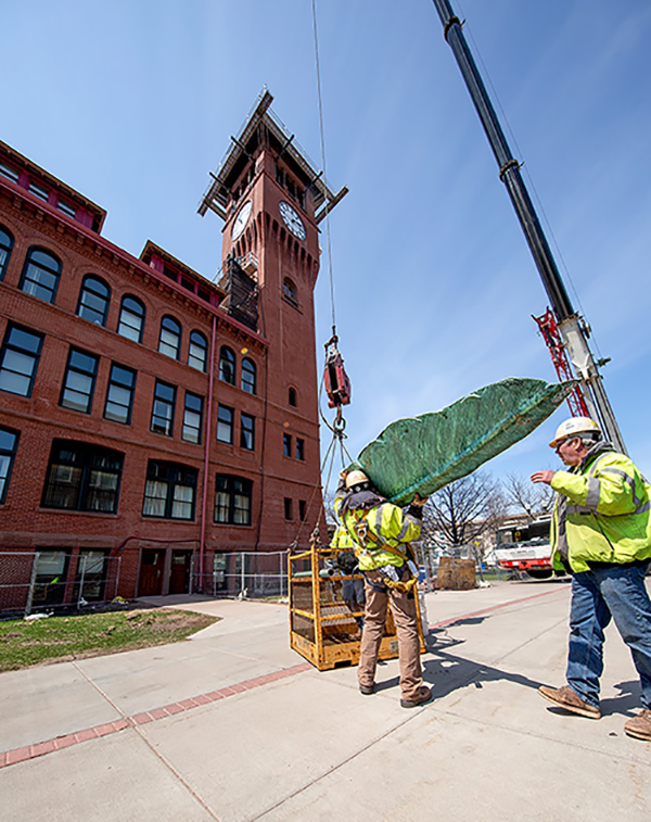 The quill is loaded into a bucket before being lifted by a crane to the top of Bowman Hall.