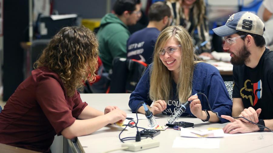 Technology education students learn to solder electronic circuit components in the tech ed lab in the Communication Technologies building.