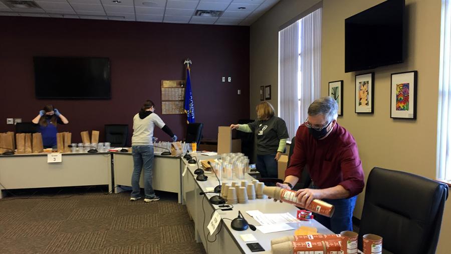 Xcel Energy volunteers assembly plant kits at the Menomonie School District Administration Building.