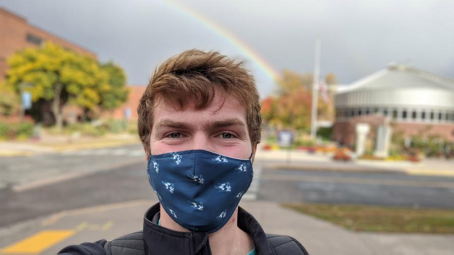 Stout Scholar Nathan Thompson with a rainbow over campus. Spring 2021.