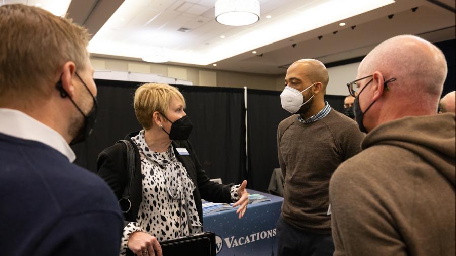 Chancellor Katherine Frank and Lt. Gov. Mandela Barnes talk with employers Chris Kandziora, left, and Pete Hayda at the Spring Career Conference on Feb. 28 at the Memorial Student Center.