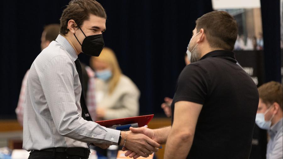 A UW-Stout student meets an employer recently at the Spring Career Conference. 