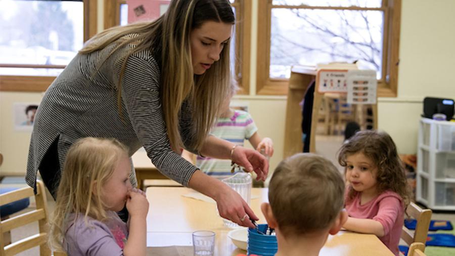 An early childhood education student works with preschoolers