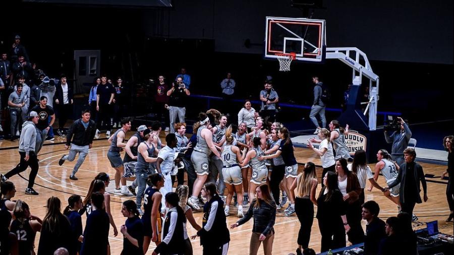 Players and fans flood the court at Johnson Fieldhouse after the Blue Devils earned their first conference title in 16 years.