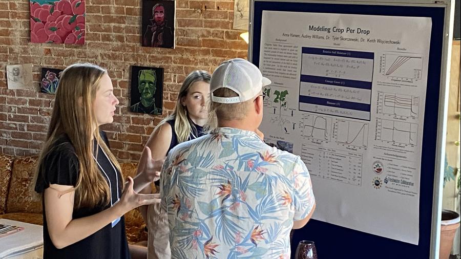 UW-Stout students Anna Hansen, left, and Audrey Williams discuss their Crop Per Drop field moisture research project that began in 2022 with a Freshwater Collaborative of Wisconsin grant.