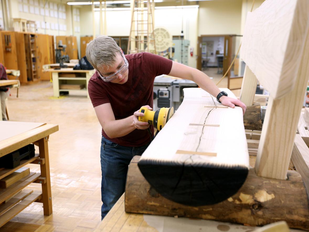 Max Mueller, majoring in engineering technology, works on a bench.