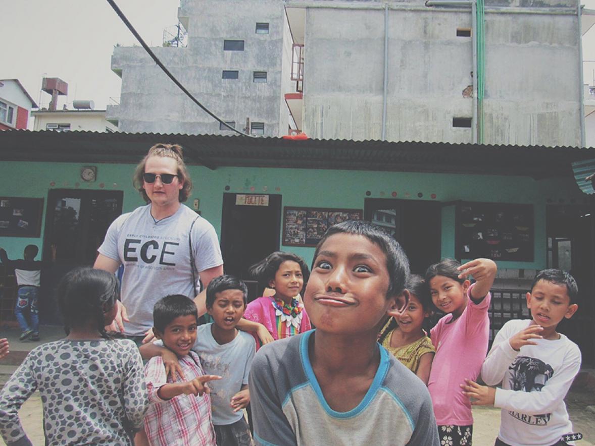 Dylan Lubs, pictured in a playground area with students, visited Nepal and taught there for a month.