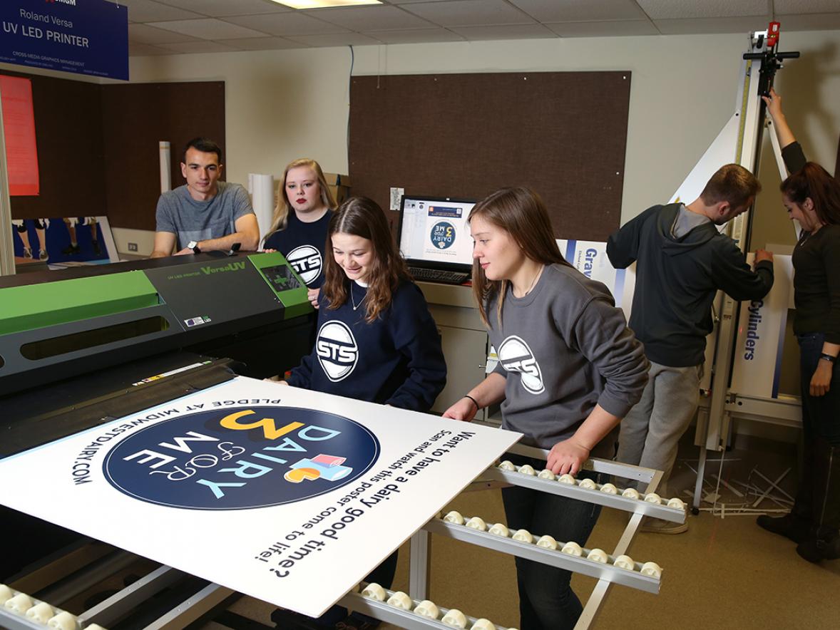 Graphic communications students work in a printing lab.