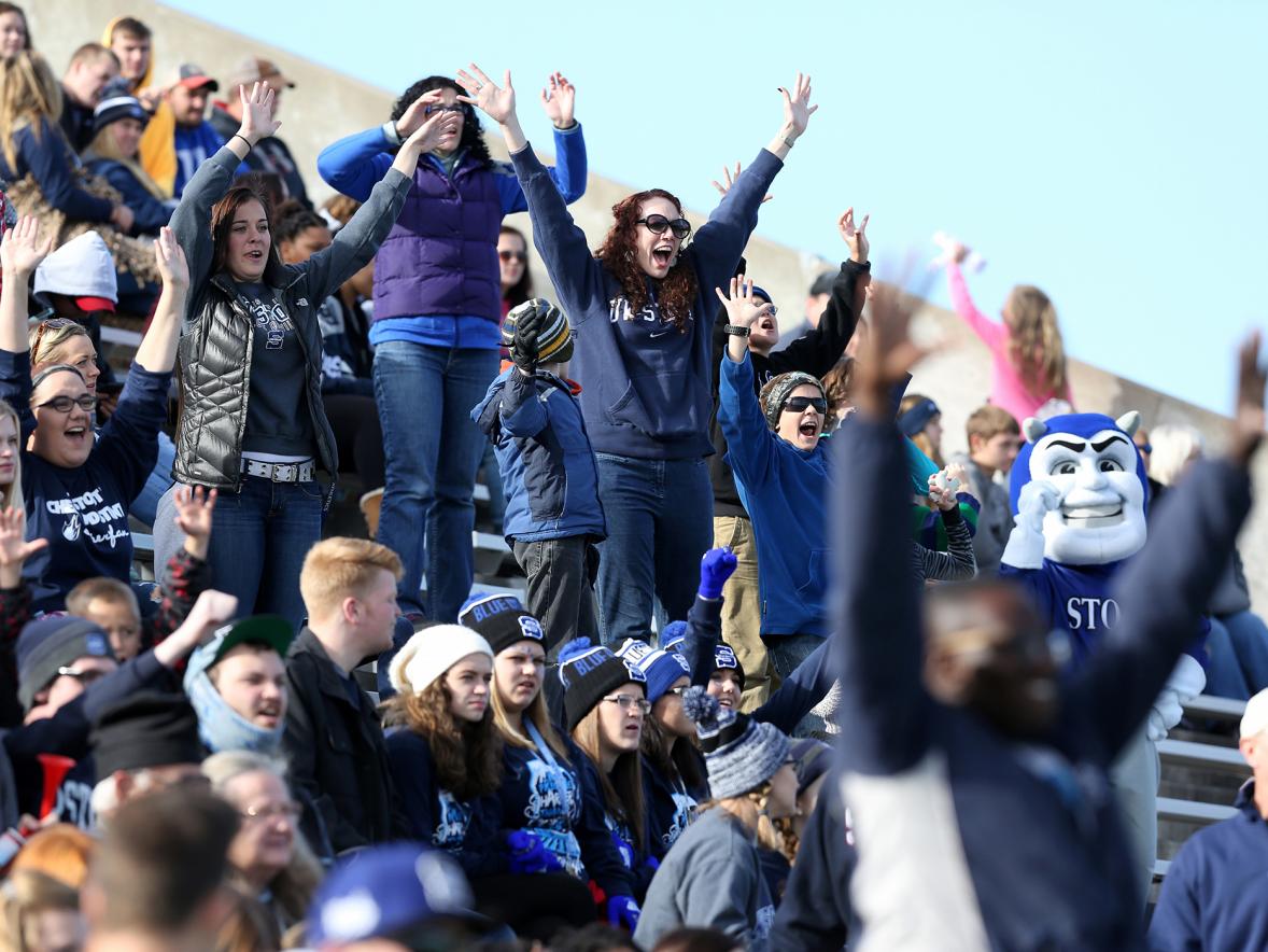 UW-Stout fans, including the mascot Blaze, cheer on the Blue Devil football team. The first Fam Jam weekend at UW-Stout is focused around the Oct. 26 football game against UW-Stevens Point.