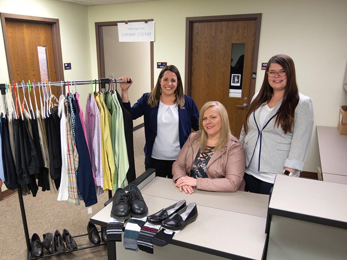 Katie Hauge, at left, Career Services employee relations manager, with Jennifer Krueger, and Chantel Formeister, of Mason Companies, show items donated by Mason Companies to the university career closet.