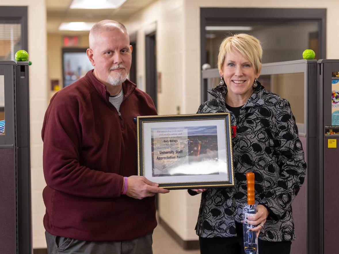 Gary Ridings, left, receives the January University Staff Employee Appreciation award from Chancellor Katherine Frank.