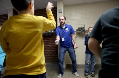 UW-Stout alumni Ashley DeMuth and Josh Sales lead the Menomonie chapter of the Boys & Girls Club of the Greater Chippewa Valley, which opened in October 2014 at River Heights Elementary School. Sales, who serves as the Club's program coordinator, is pictured leading an activity with students in the after school program