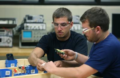 UW-Stout Engineering Technology students working on an electrical system.