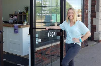 Photo of Rachel Funk-Johnson in front of Happy Apple Therapy Center