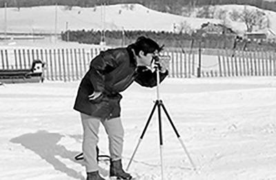 Arthur Nakatani looking through a camera