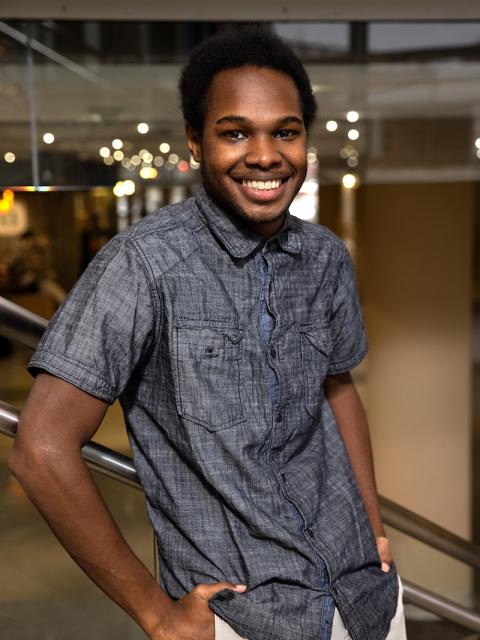 Deon Canon, double major graduate in professional communication and emerging media and applied social sciences, in the Memorial Student Center grand stairwell.